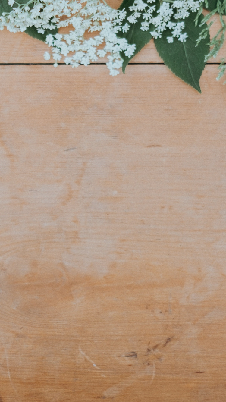 Imagen de una tabla de madera con flores encima